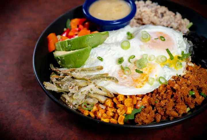 Burrito breakfast bowl with a fried egg and avocado
