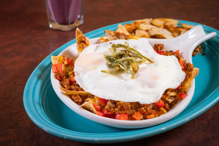 Crispy huevos topped with a fried egg