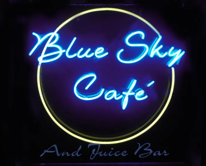 The neon Blue Sky Café and Juice Bar sign